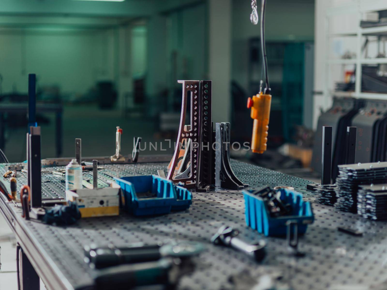 A smart factory worker or engineer makes machines in a production workshop. The concept of industry and engineering. Selective focus. High-quality photo