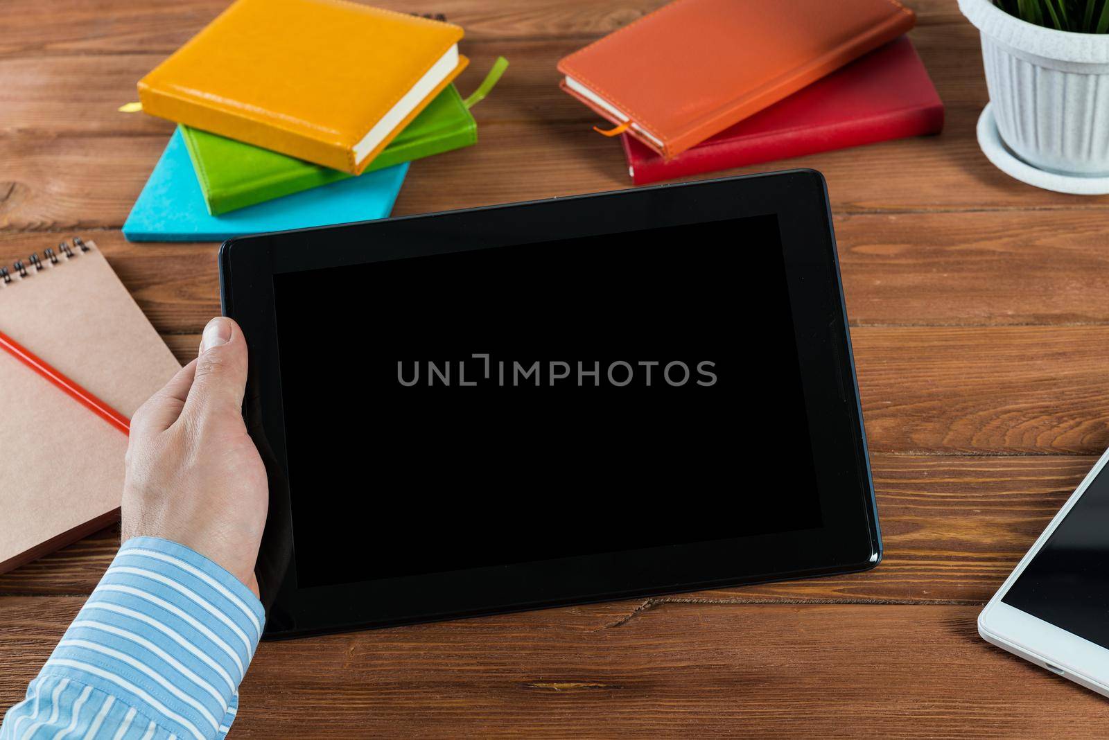 close-up of men's hands with a computer tablet. Businessman works in the office