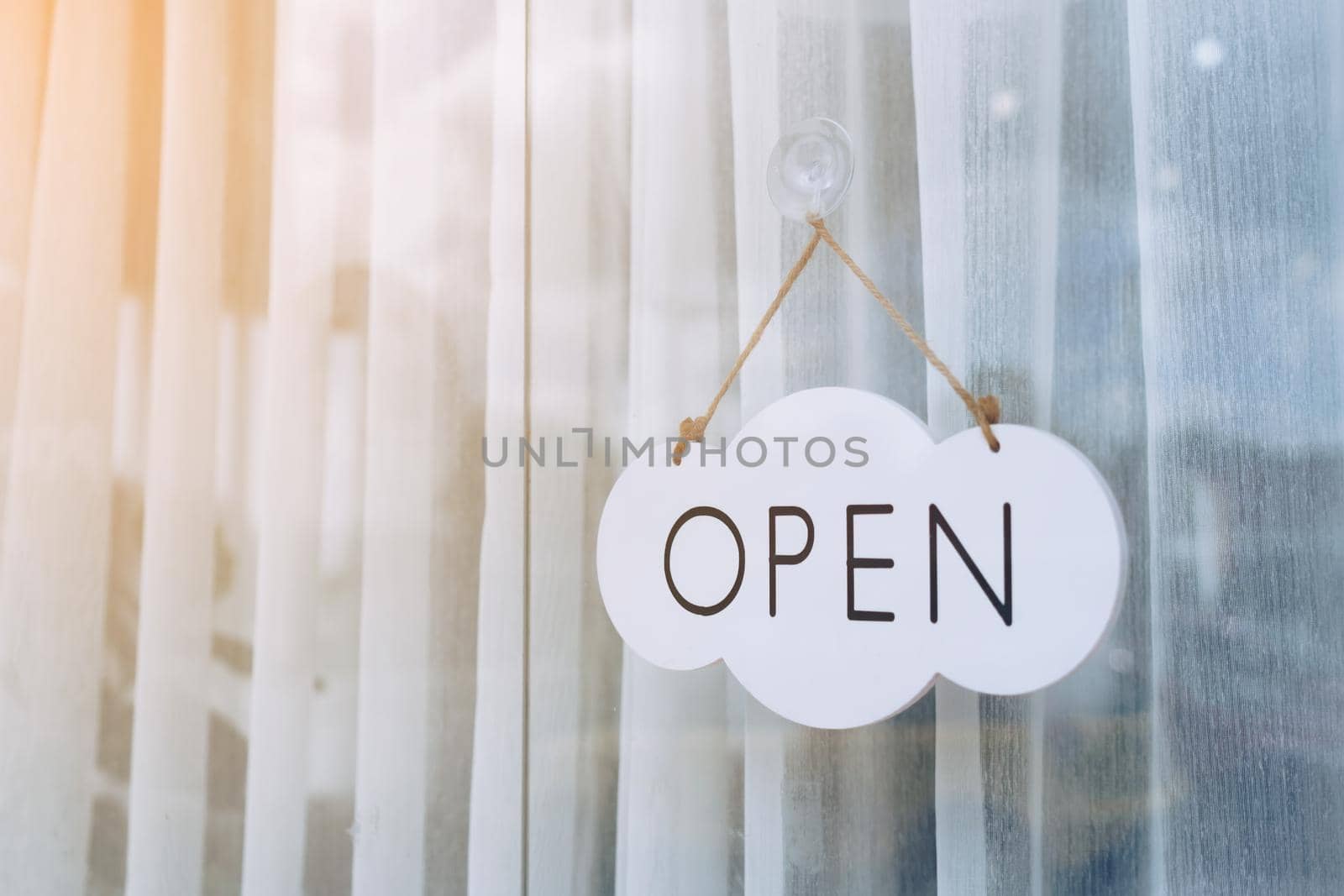 A business sign that says Open on cafe or restaurant hang on door at entrance.  by Suwant
