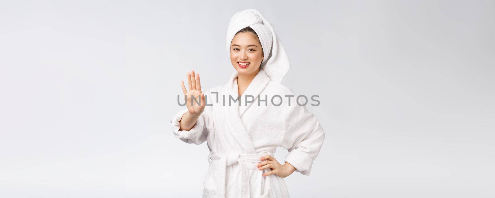 beauty asian girl who checks her skin. skin care. Isolated over white background