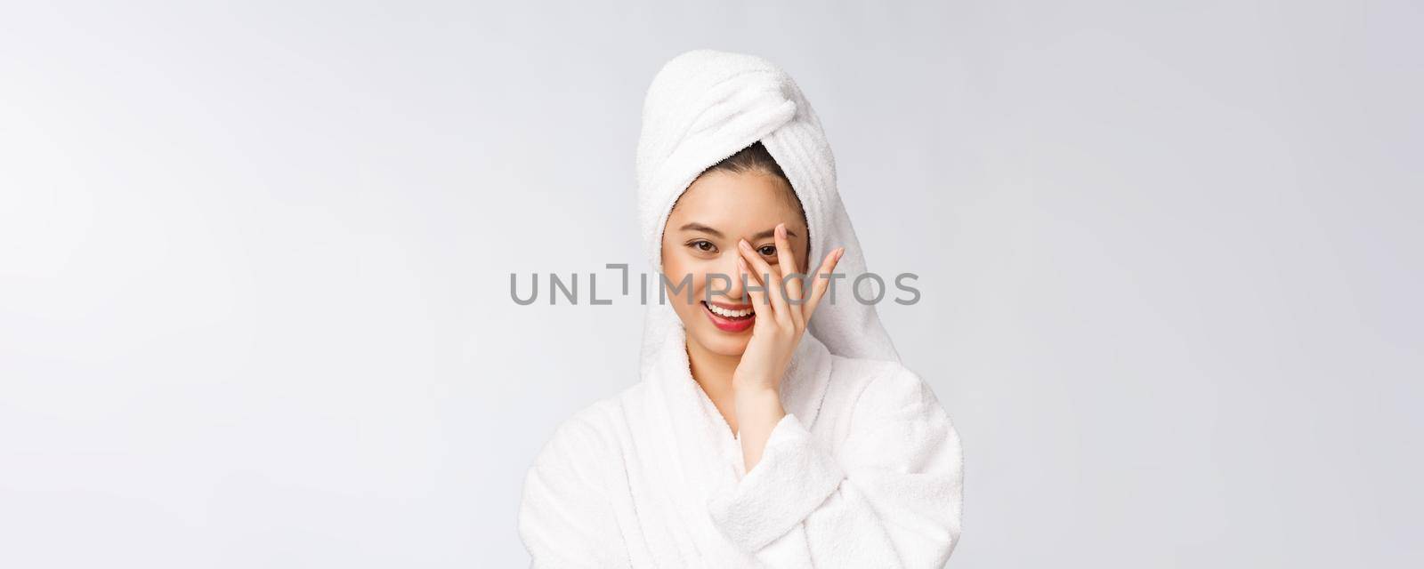 Spa skincare beauty Asian woman drying hair with towel on head after shower treatment. Beautiful multiracial young girl touching soft skin.