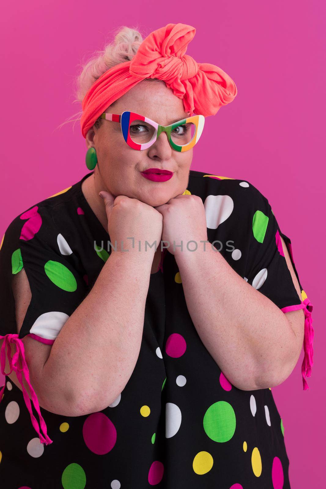 Happy Plus Size Woman Wearing Eyeglasses Smiling To Camera Standing Over Pink Background. Cheerful Millennial Female In Eyewear Posing In Studio. High quality photo