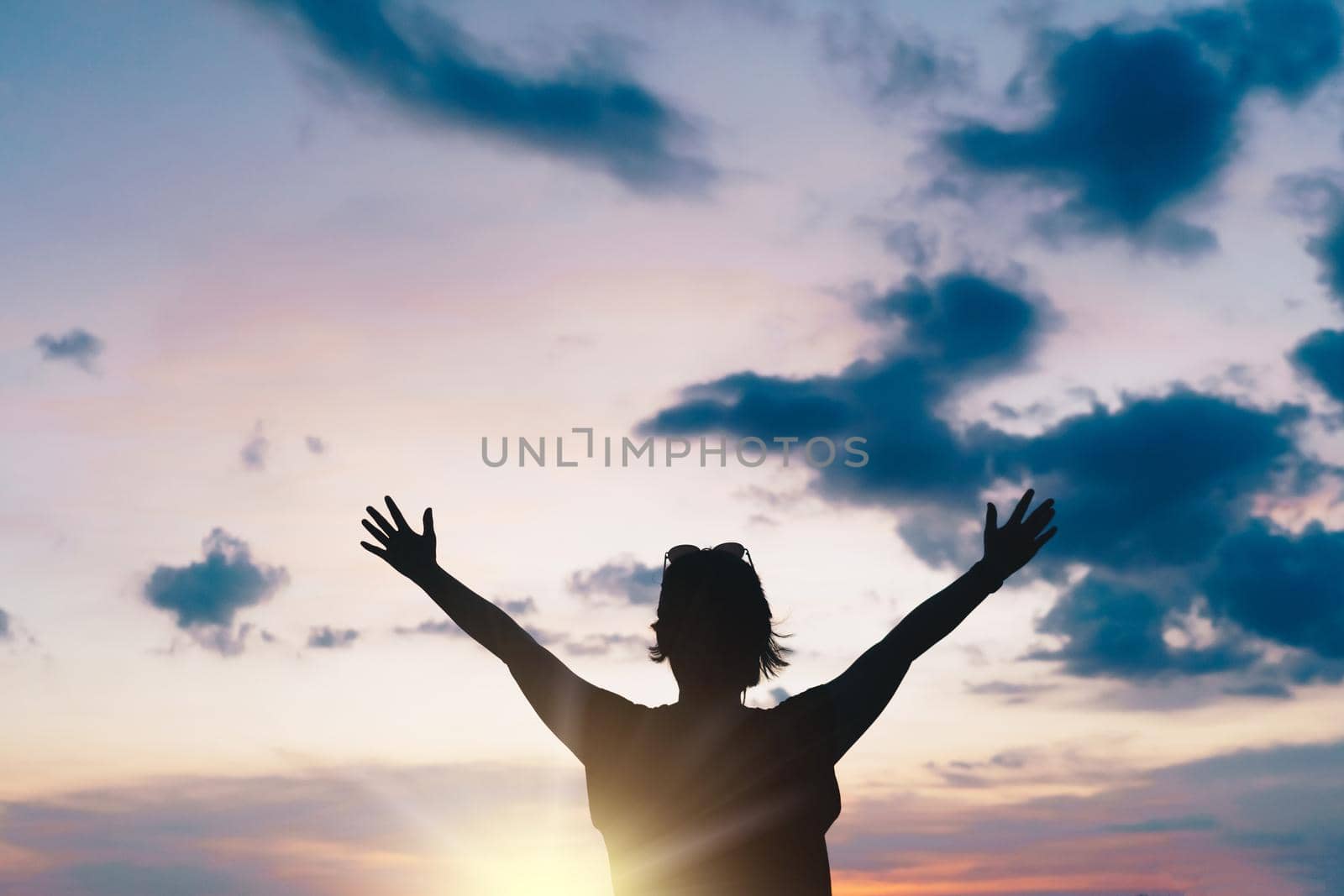 Woman rise hand to sky show freedom and travel around the world with summer beach relax life concept.