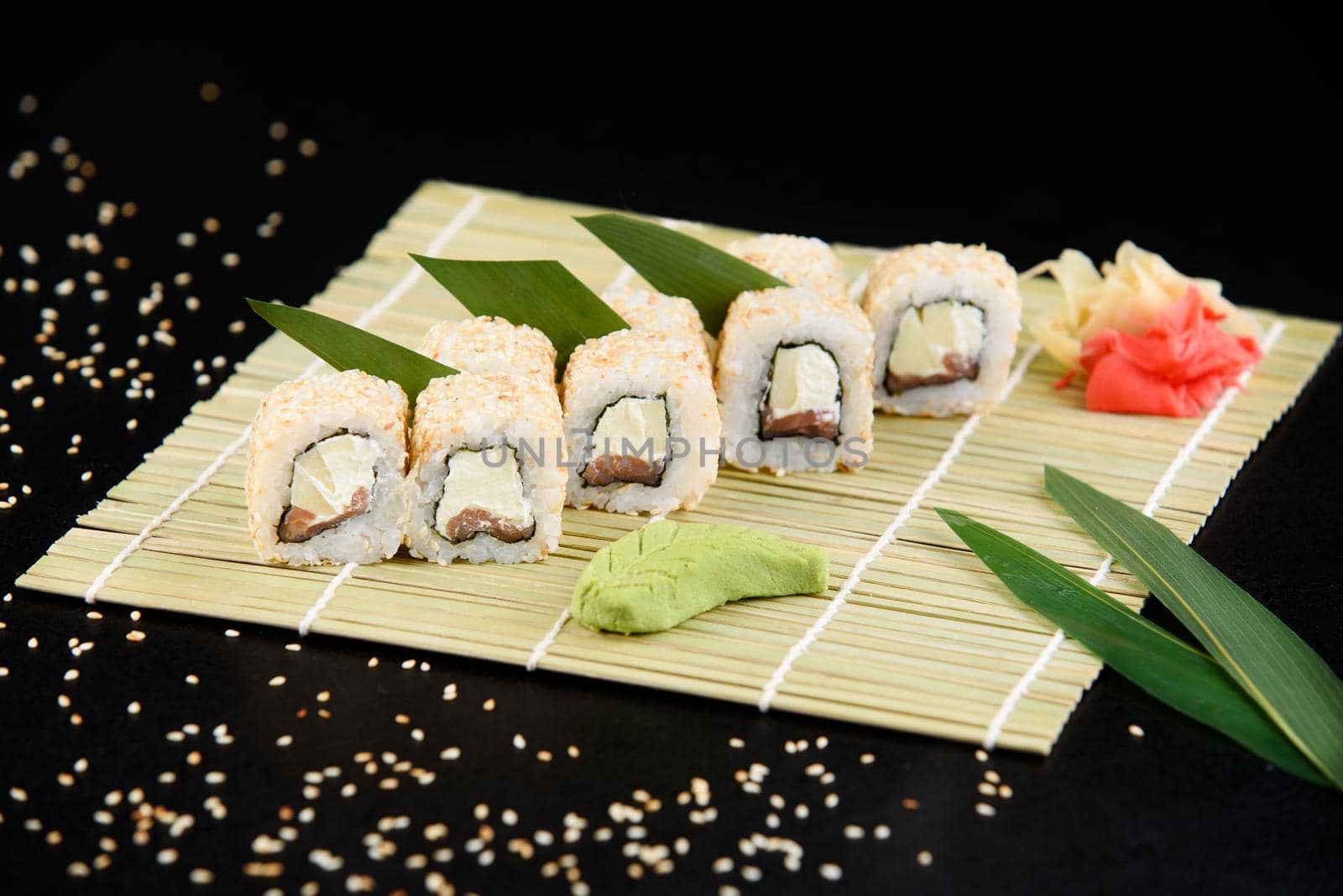 Sushi roll sea food on black background. Sushi delivery from the restaurant. Fresh delicious Japanese sushi with avocado, cucumber, shrimp and caviar on dark background. by Rabizo