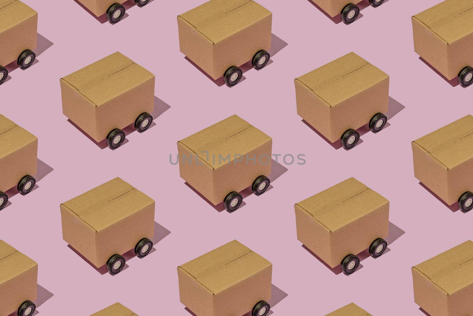 Cardboard boxes on wheels like trucks carry parcels and make deliveries.  by sergii_gnatiuk