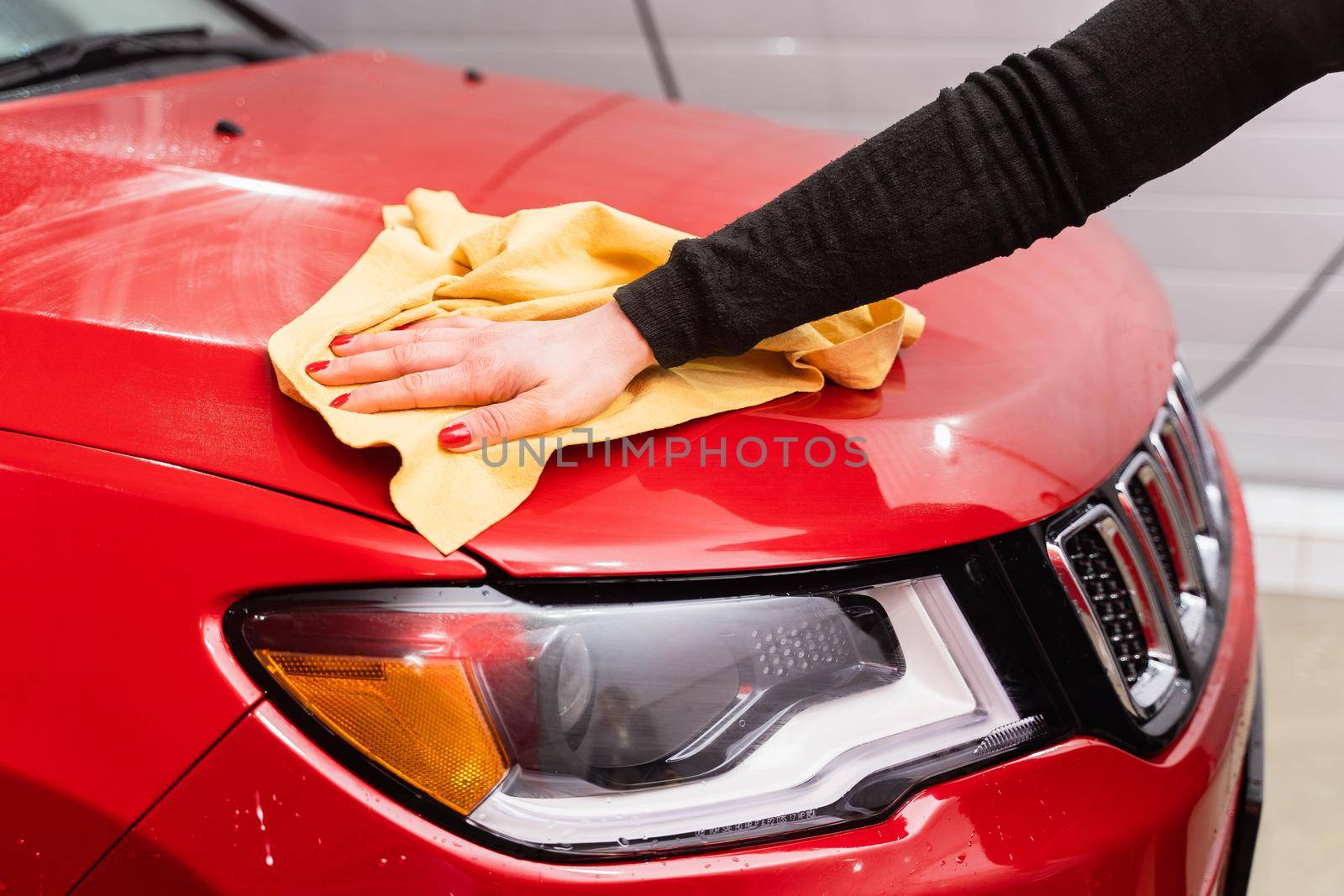 Car polishing with yellow microfiber cloth. Protection of paintwork.