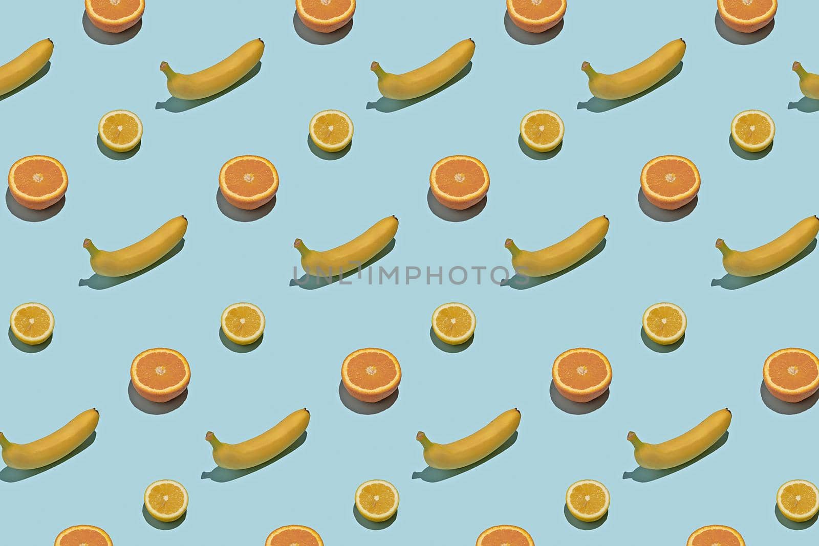 Summer fresh fruit food concept pattern. Tropical fruits on a blue background.