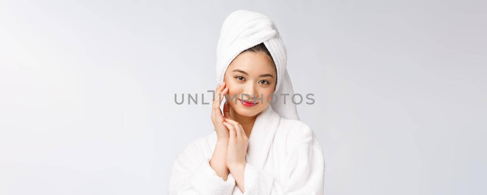 Spa skincare beauty Asian woman drying hair with towel on head after shower treatment. Beautiful multiracial young girl touching soft skin