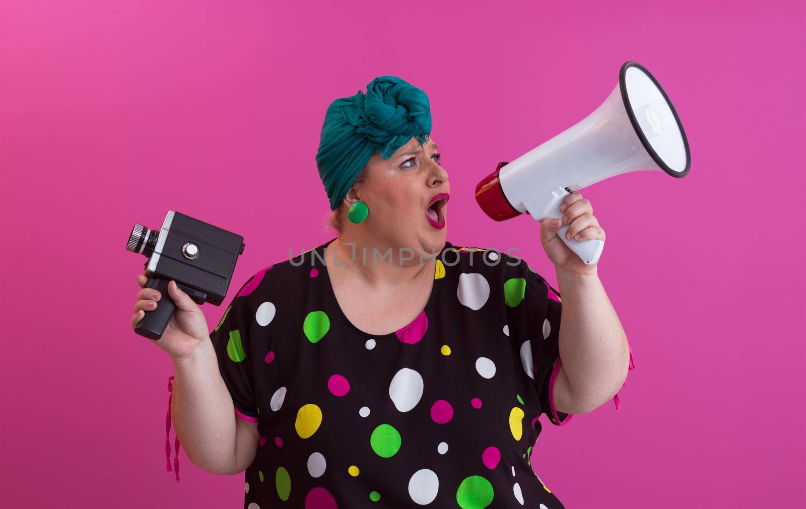 Funny plus size woman woman posing isolated on pink background studio portrait. People emotions lifestyle concept. Mock up copy space. Screaming in megaphone. High quality photo