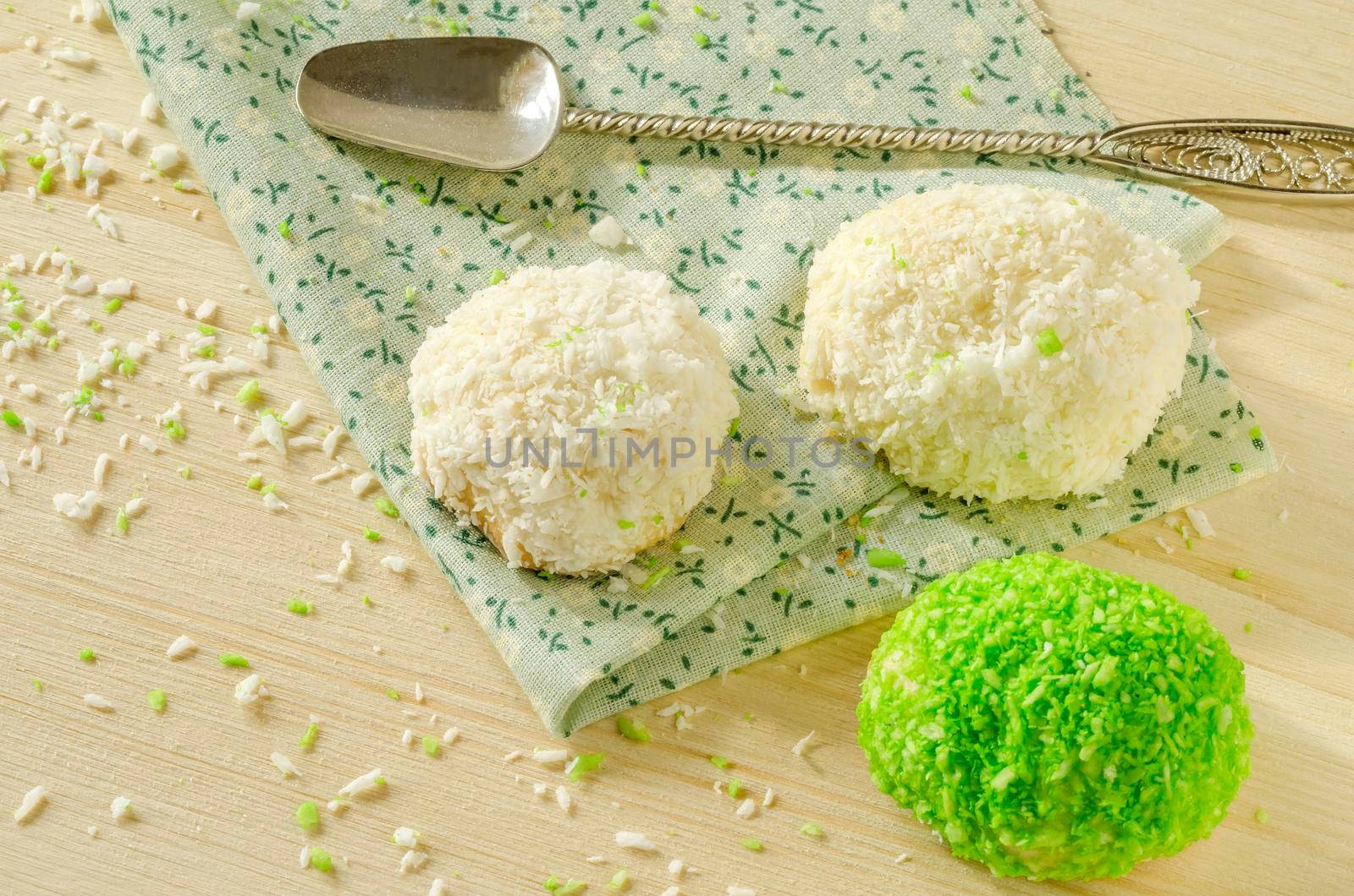 Tree cookies with coconut flakes on cotton cloth. Near spoons. Overhead view