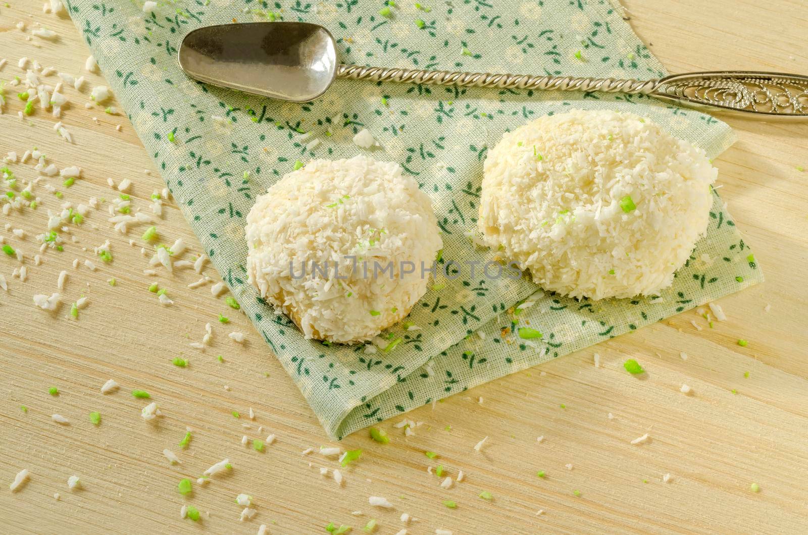 Twoo cookies with coconut flakes on cotton cloth. Near spoon.. Overhead view