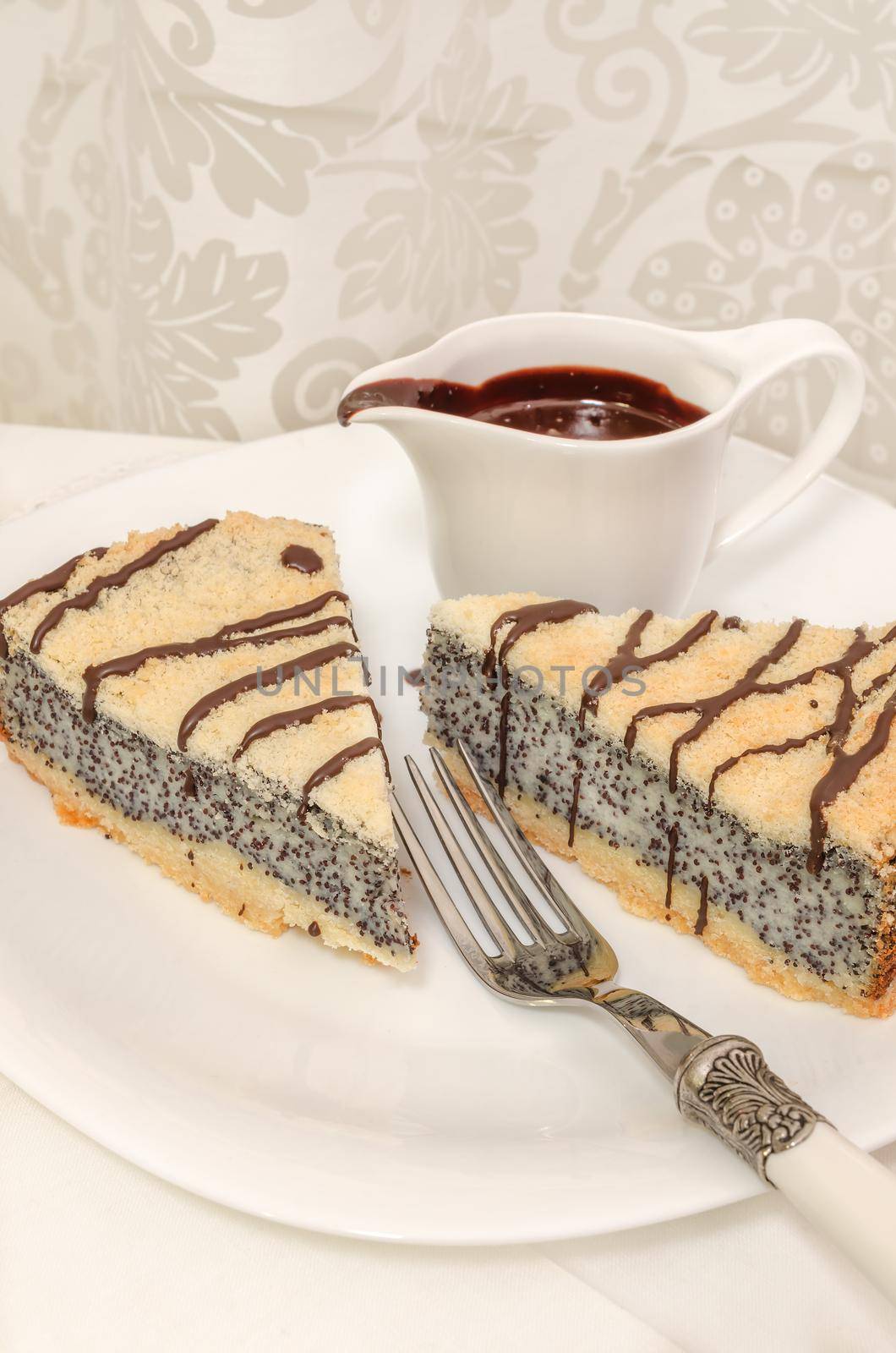 German poppy seed cake on white plate with chocolate and coffee