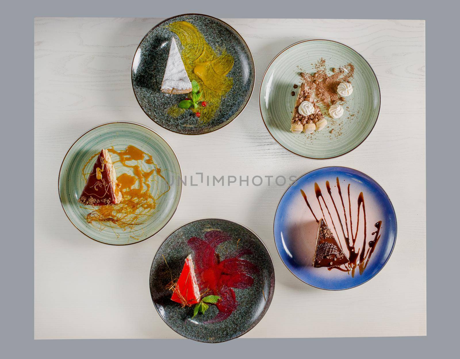 Assortment of pieces of cake on table, copy space. Several slices of delicious desserts, restaurant menu concept, top view.