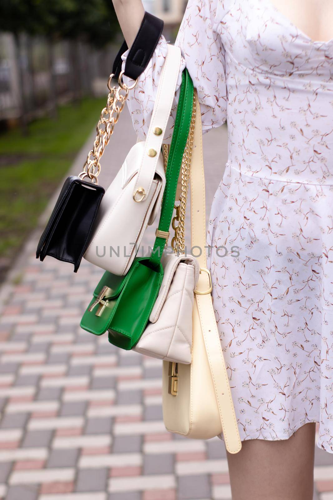 woman hand holding set of colorful bags. Product composition photography. handbag and purse for women by oliavesna