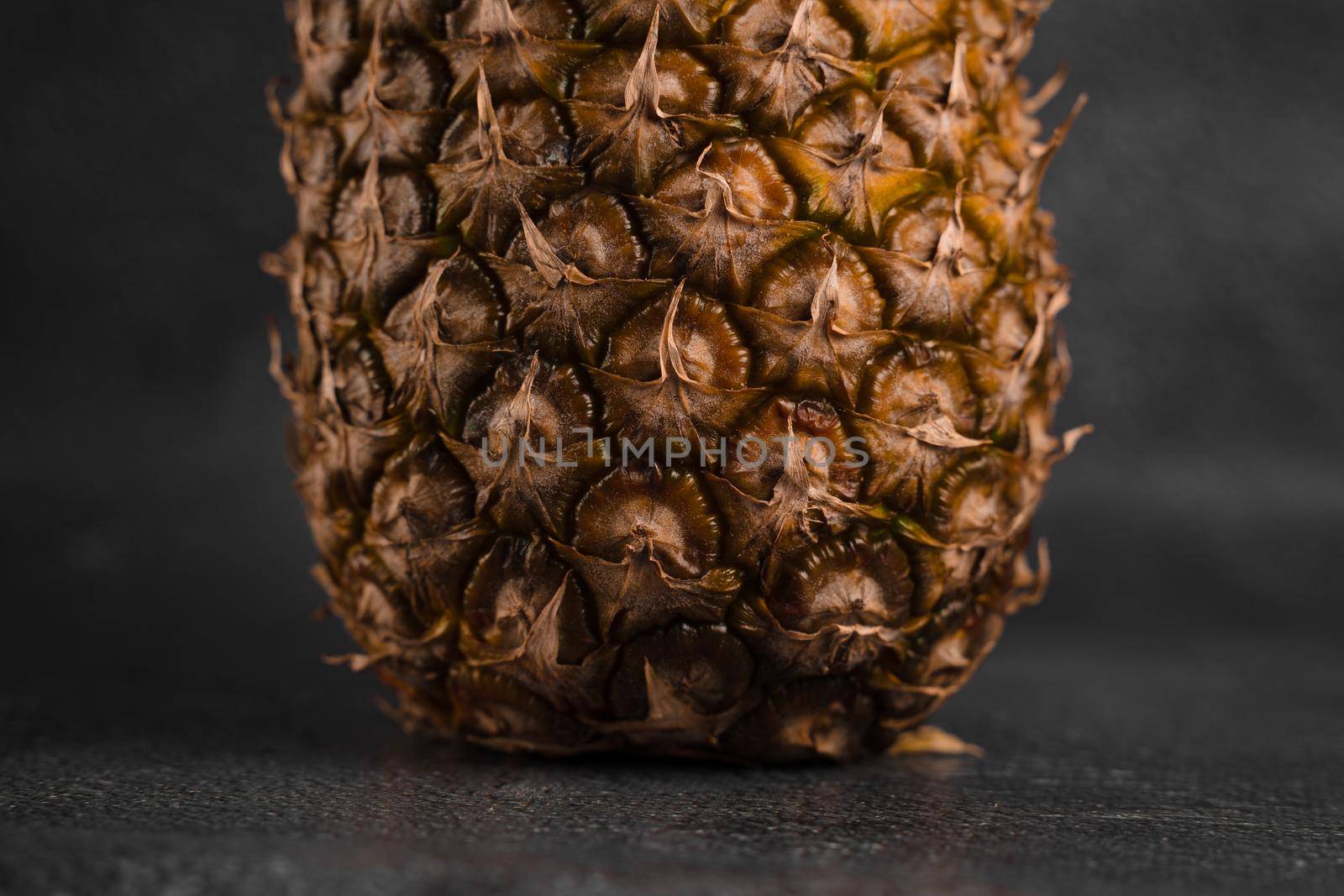 Close-up pineapple tropical fruit on dark stone background background. Citrus fruit with vitamin c for helth care