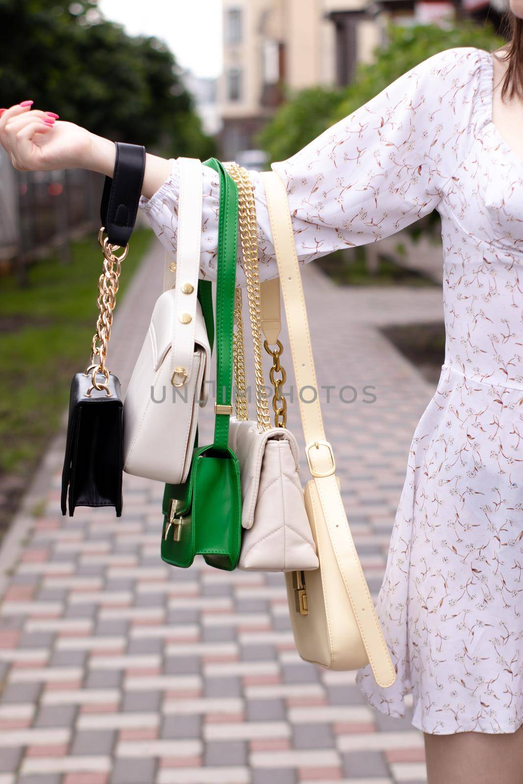woman hand holding set of colorful bags. Product composition photography. handbag and purse for women.
