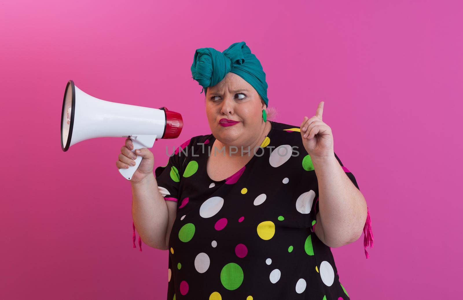 Funny plus size woman woman posing isolated on pink background studio portrait. People emotions lifestyle concept. Mock up copy space. Screaming in megaphone. by dotshock