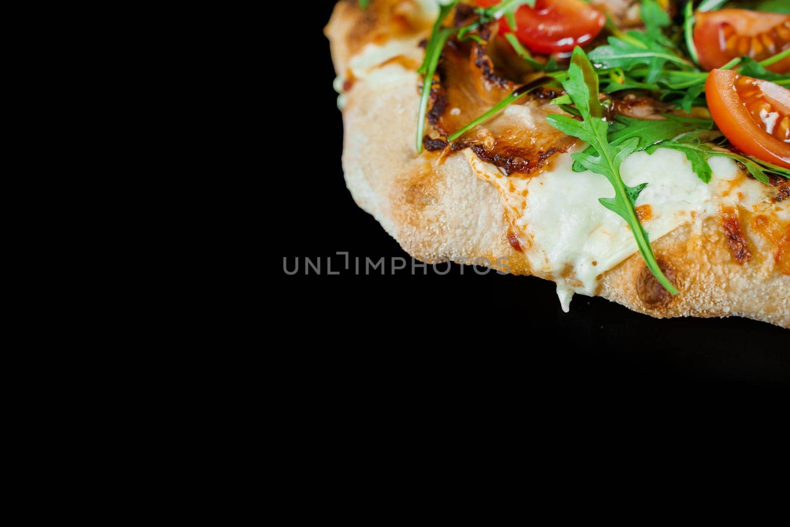 Pinsa romana gourmet italian cuisine on black background. Scrocchiarella. Pinsa with meat, arugula, tomatoes, cheese. by Rabizo