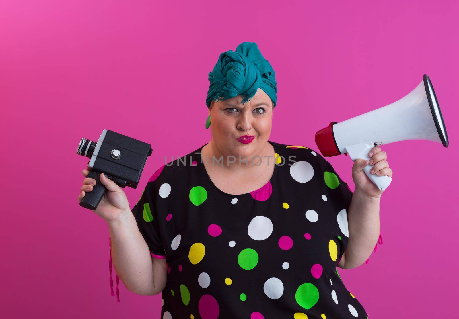 Funny plus size woman woman posing isolated on pink background studio portrait. People emotions lifestyle concept. Mock up copy space. Screaming in megaphone. by dotshock