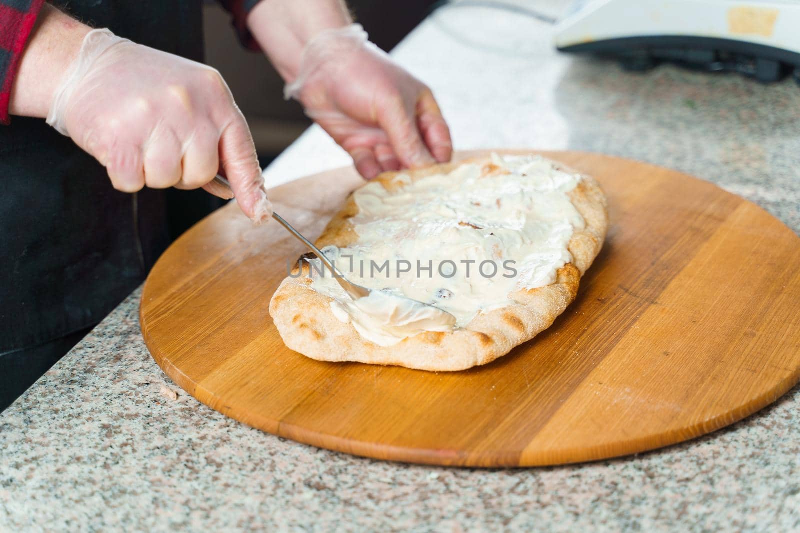 Dough for pinsa romana with cheese sauce. Scrocchiarella gourmet italian cuisine. Traditional dish