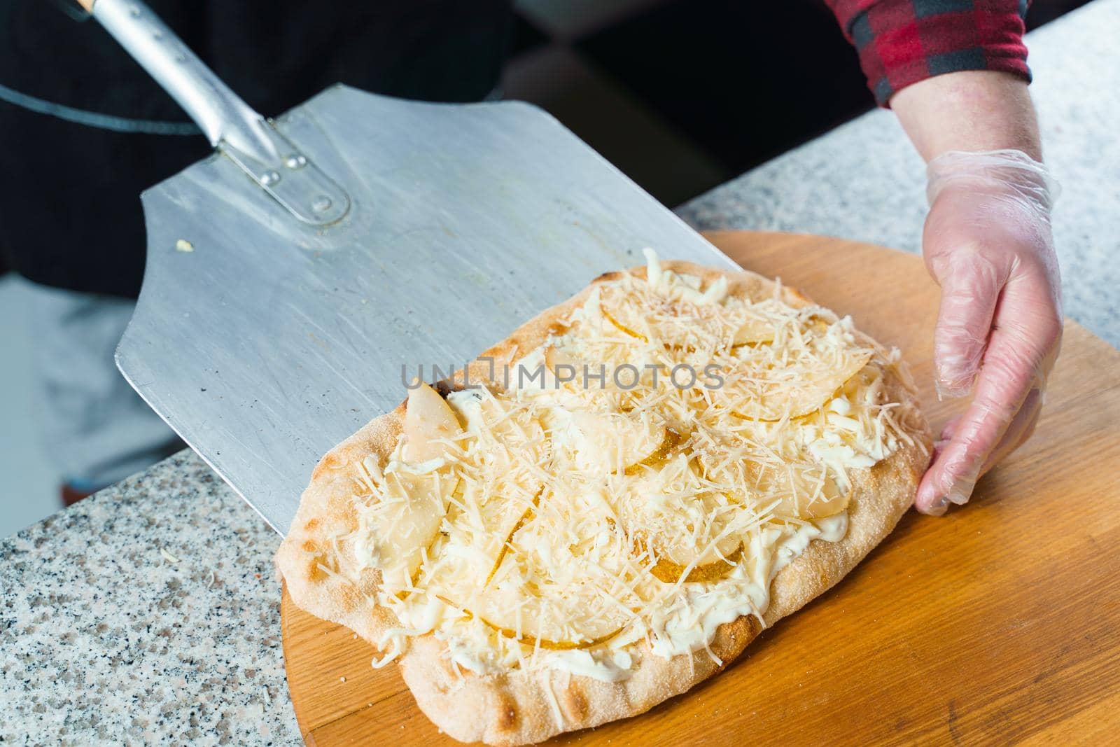 Dough for pinsa romana with cheese sauce. Scrocchiarella gourmet italian cuisine. Traditional dish