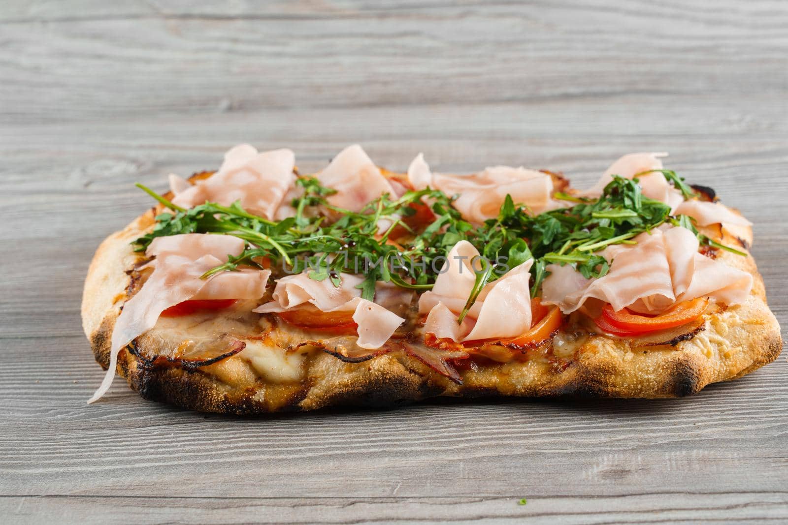 Scrocchiarella gourmet italian cuisine. Pinsa romana. Food delivery. Pinsa with meat, arugula, cheese