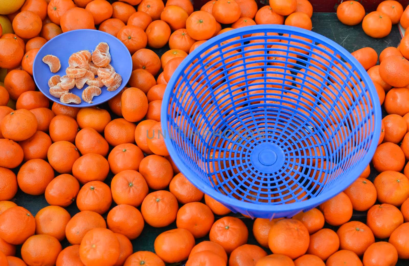 Mandarins on the market Plate with mandarin slices for tasting