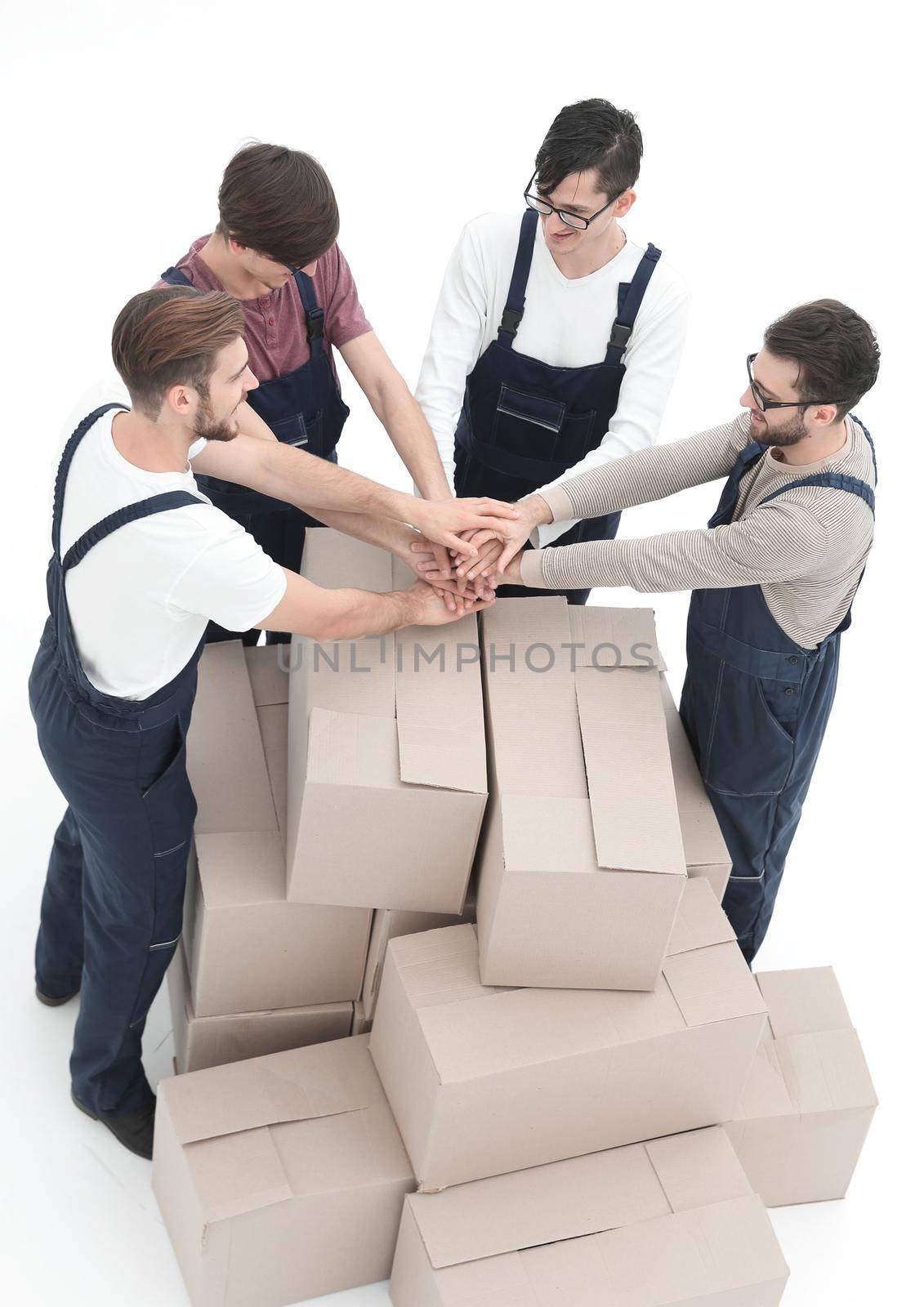 Cheerful movers leaning on stack of boxes isolated on white back by asdf