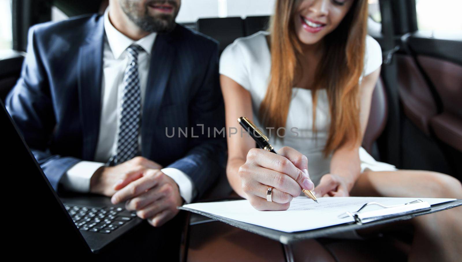 Businessman and businesswoman talking on a move by asdf