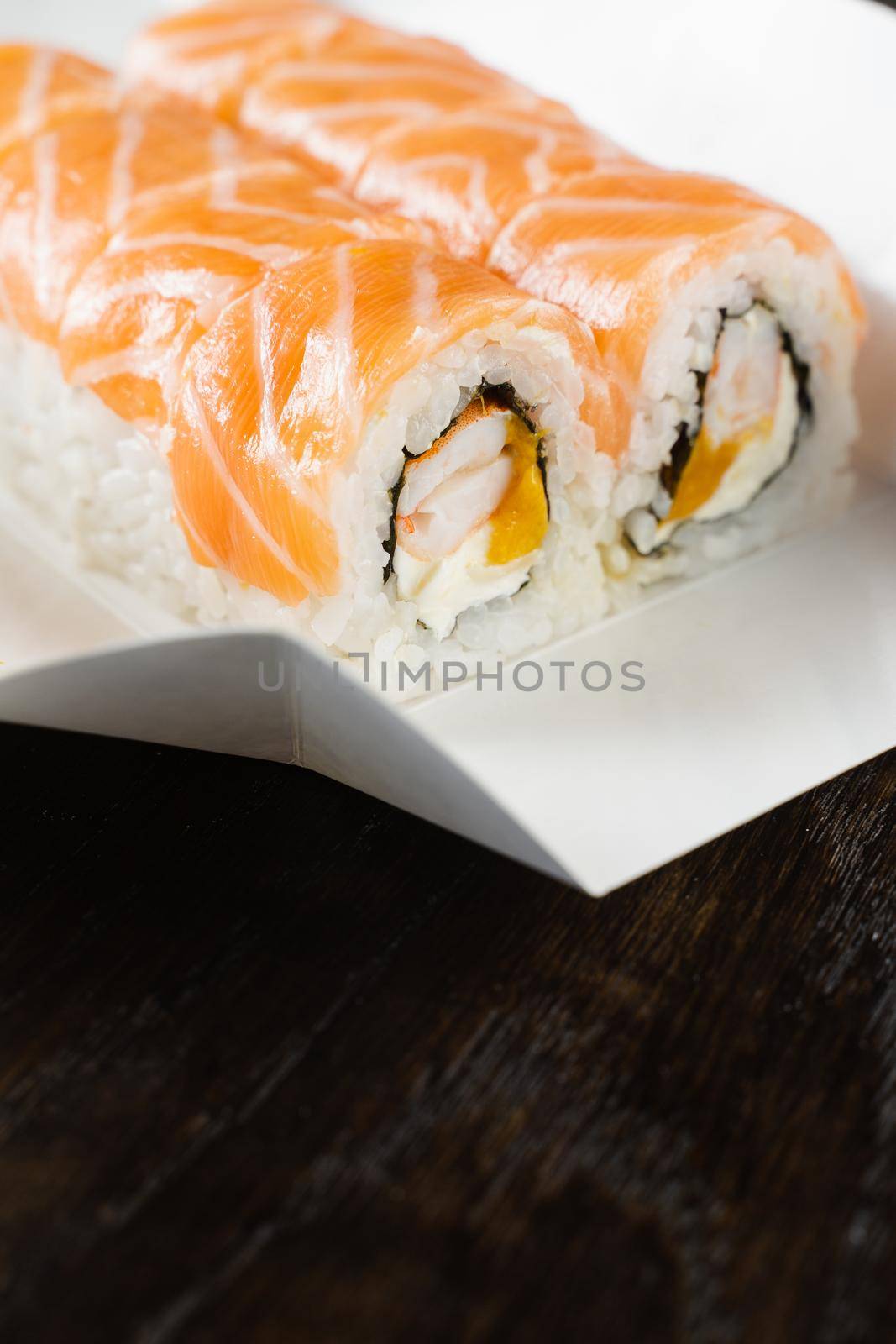 Philadelphia roll on the food delivery plate. Roll with salmon, shrimp and mango. by Rabizo