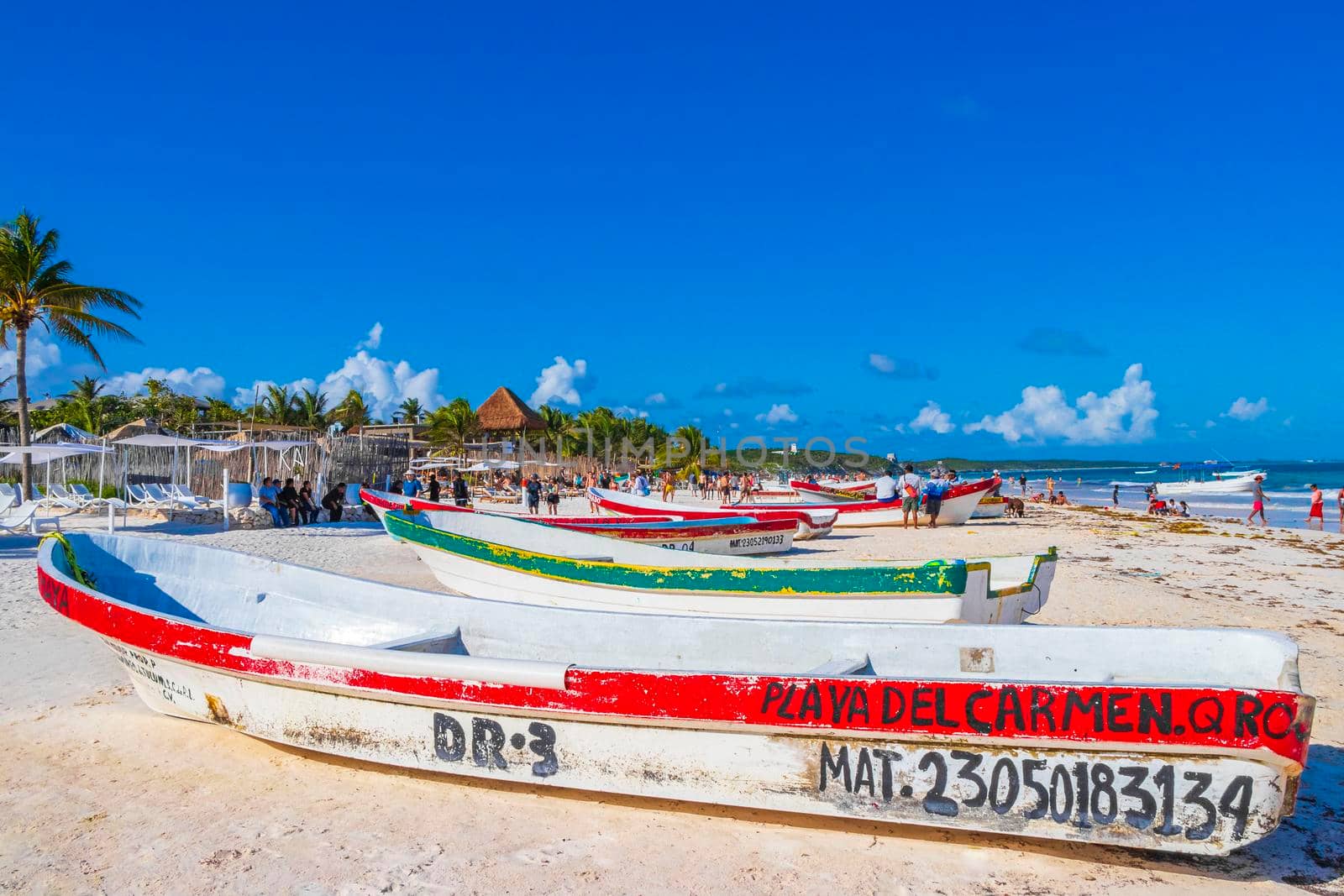 Waves boats caribbean coast and beach panorama view Tulum Mexico. by Arkadij