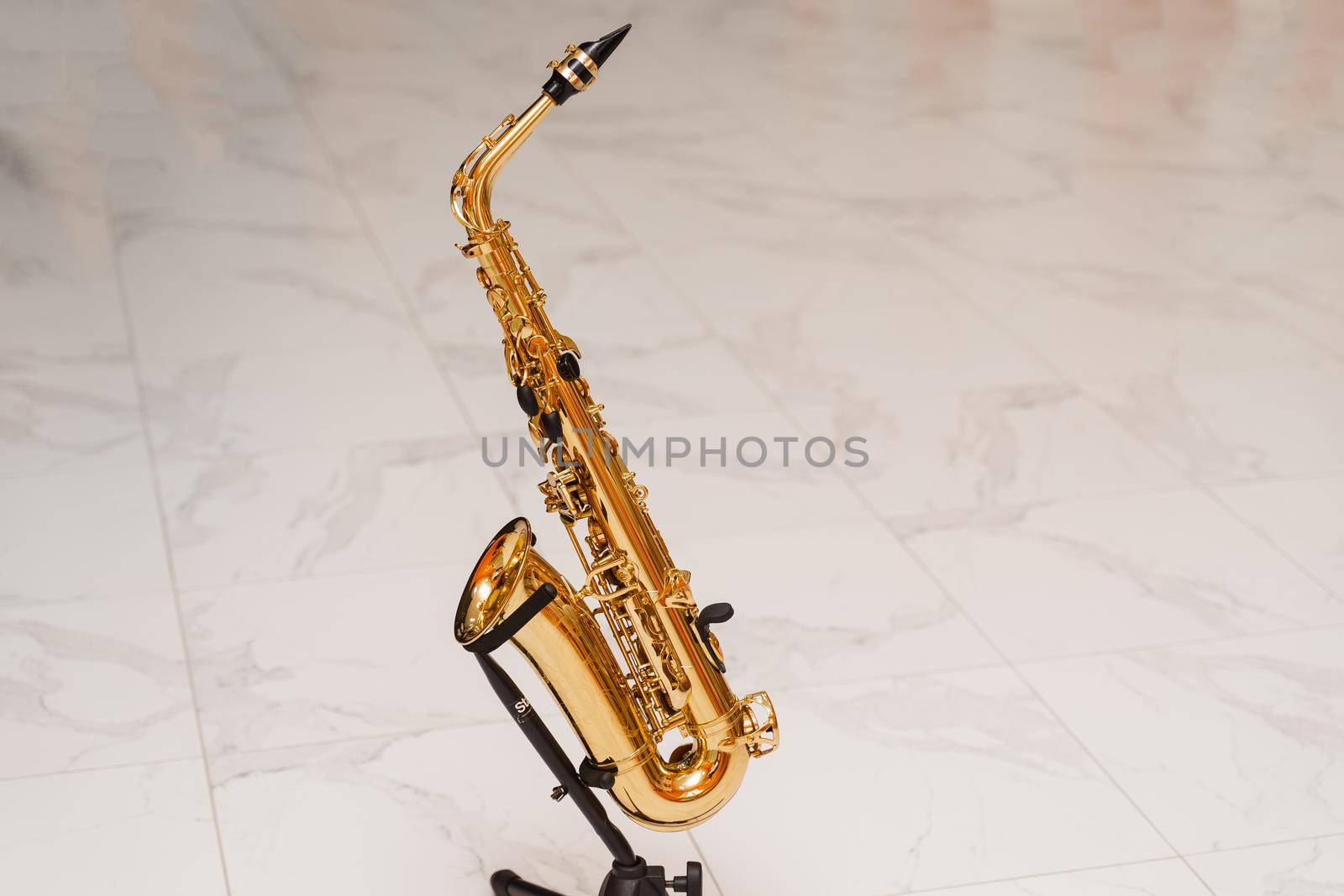 Saxophone musician instrument on stand on white background. Sax musical instrument for play jazz