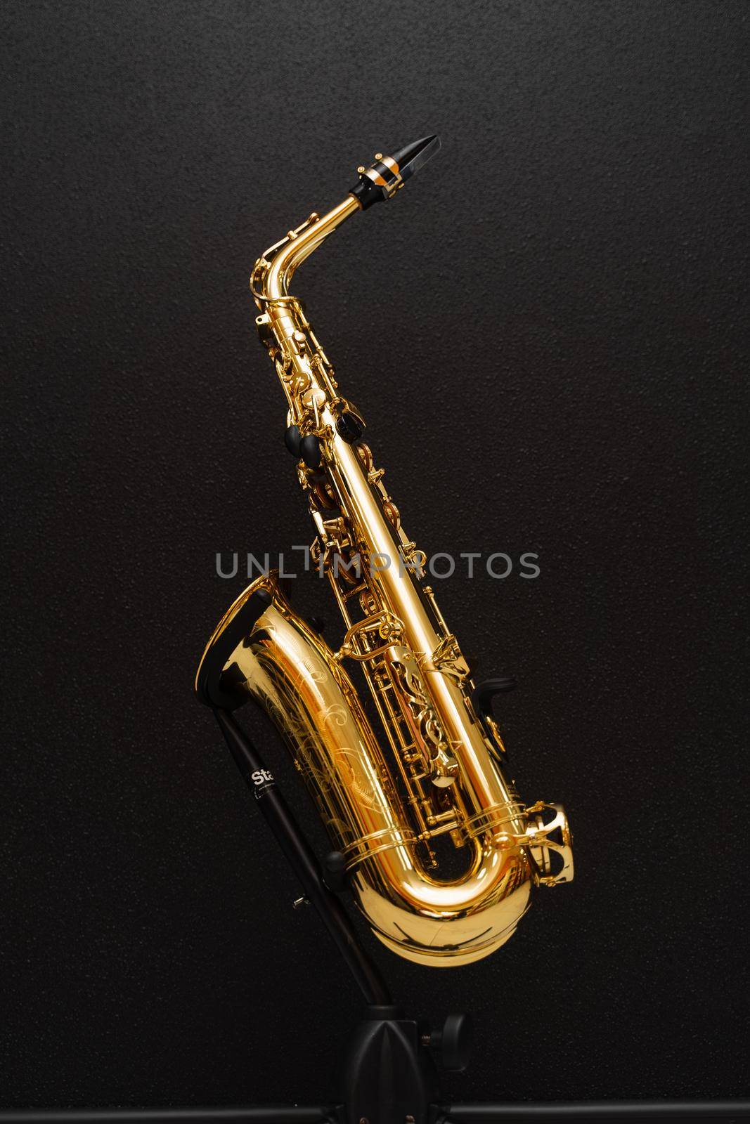 Sax musical instrument for play jazz. Saxophone musician instrument on stand on black background