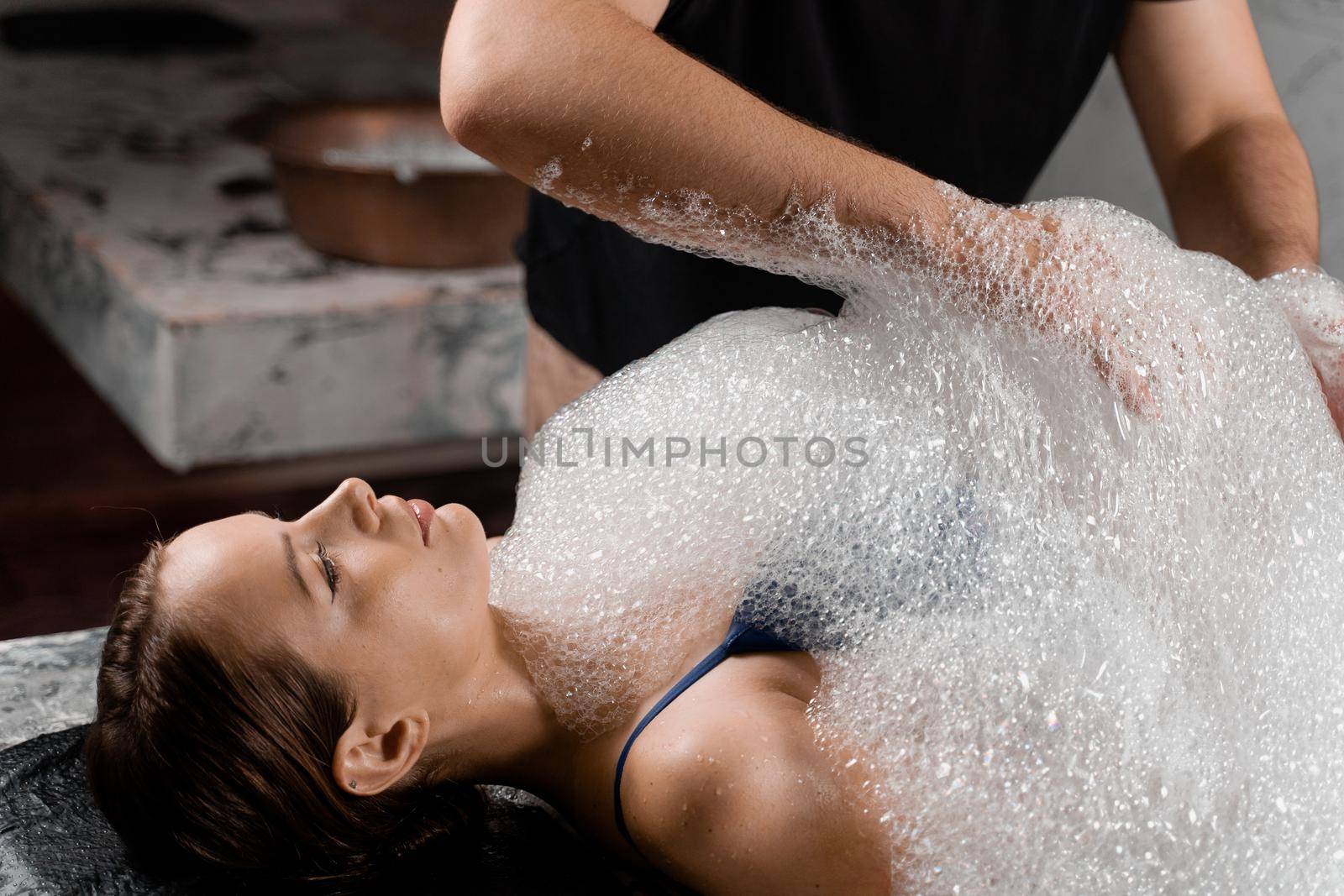 Turkish hammam spa procedure. Foam peeling massage for body. by Rabizo