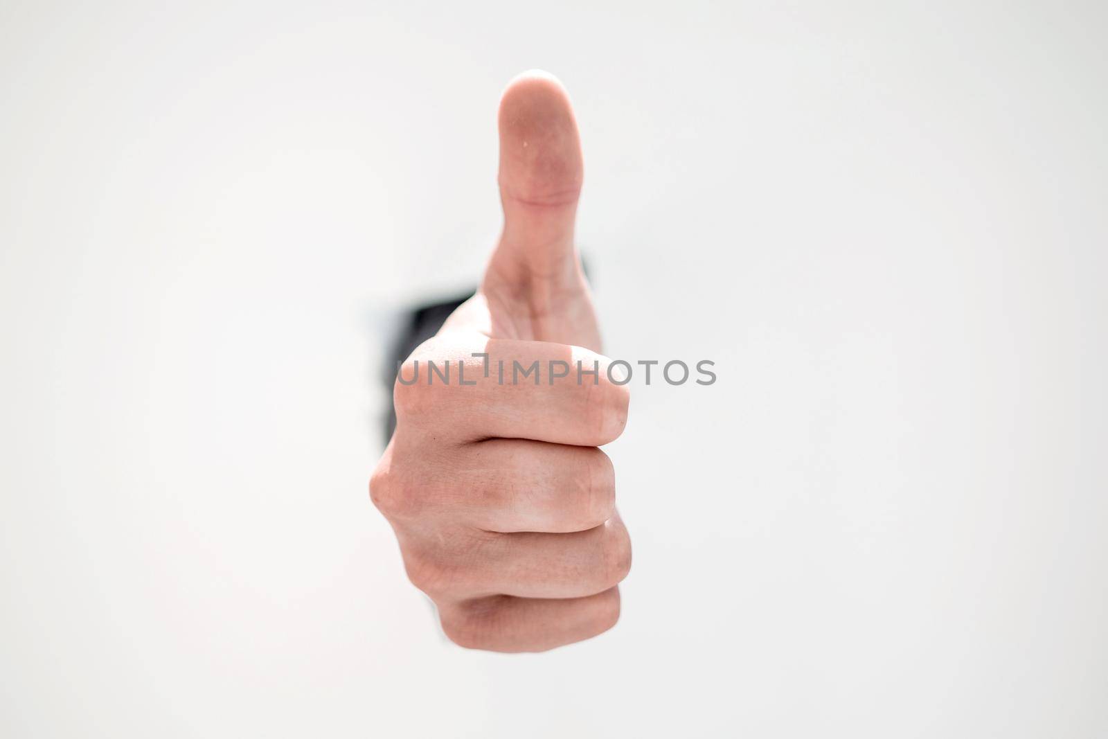 businessman breaking through the paper wall and pointing at you.photo with copy space