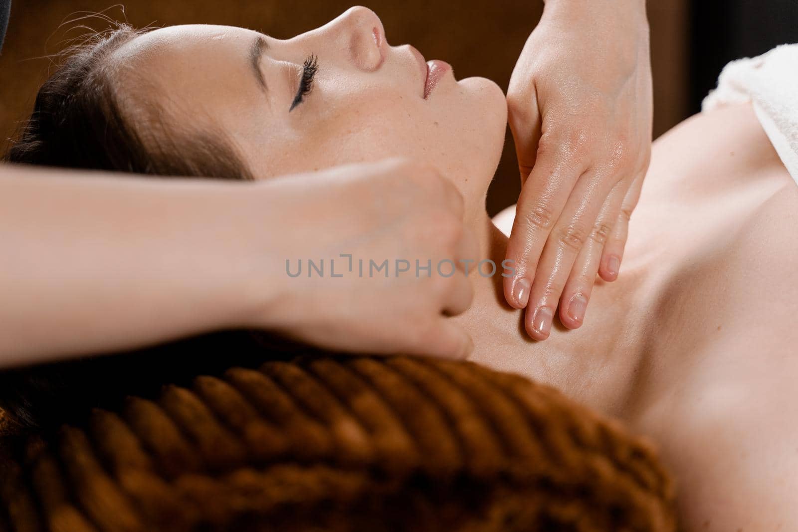 Neck and face massage in the spa. Beauty treatments for an attractive female model. Relaxation, by Rabizo