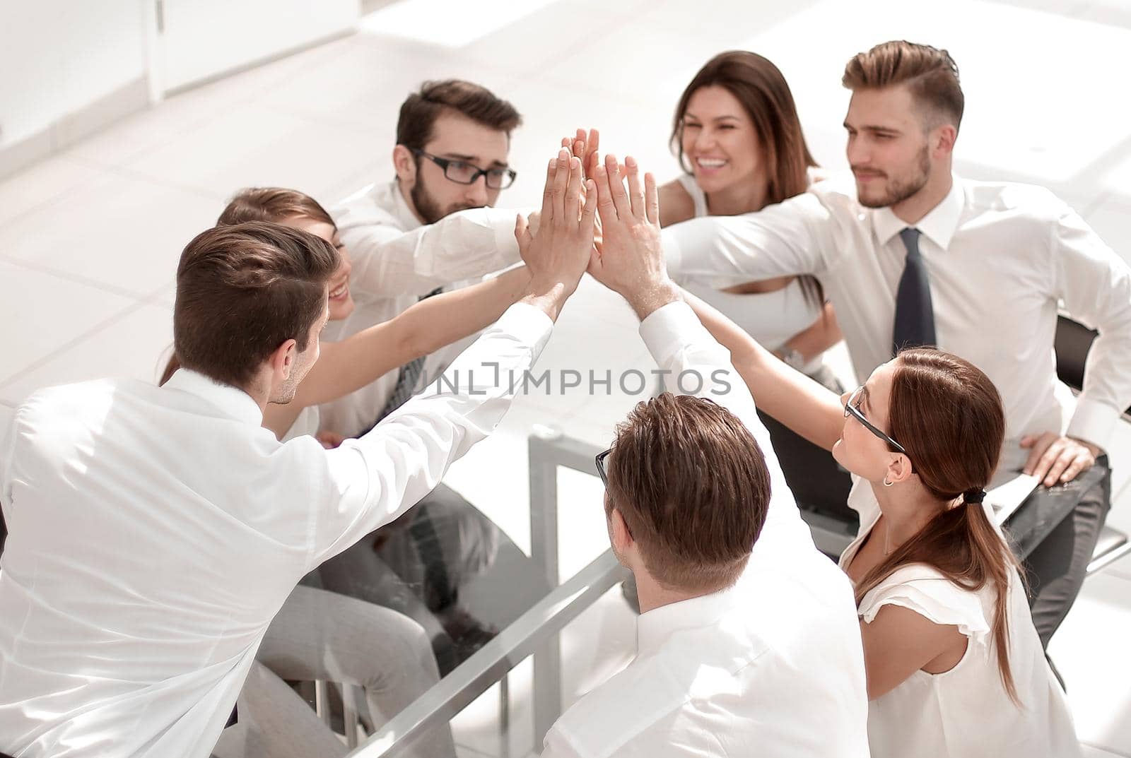 successful business team giving each other a high five by asdf