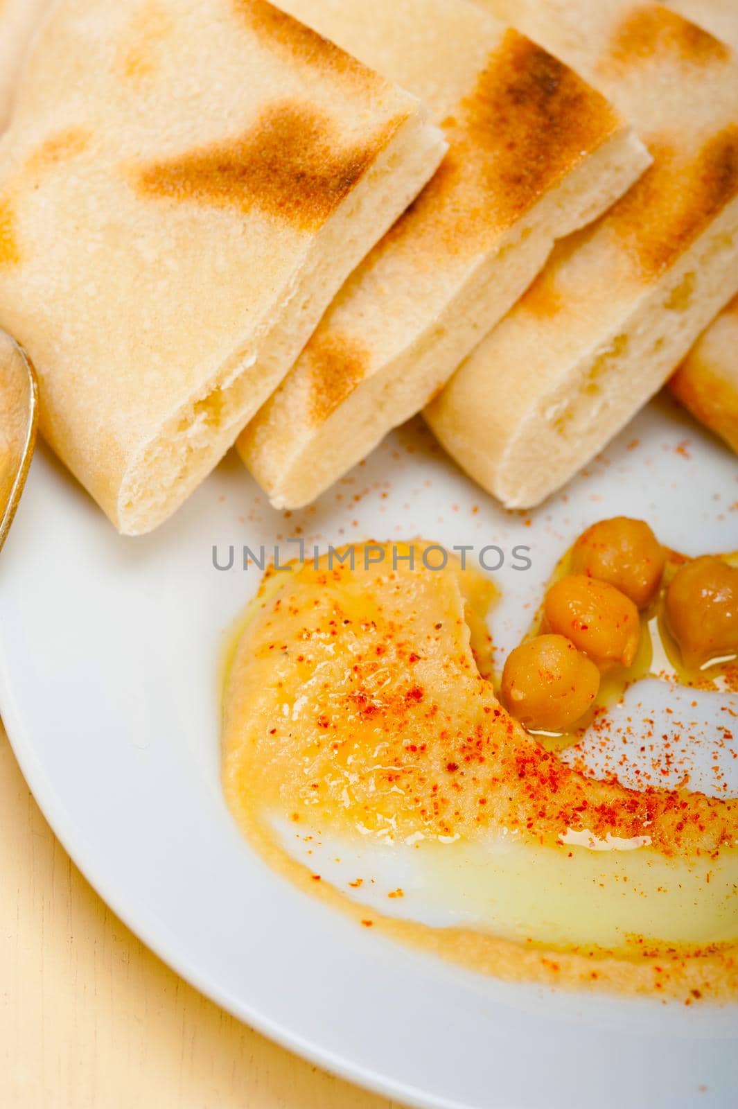 traditional chickpeas Hummus with pita bread and paprika on top 