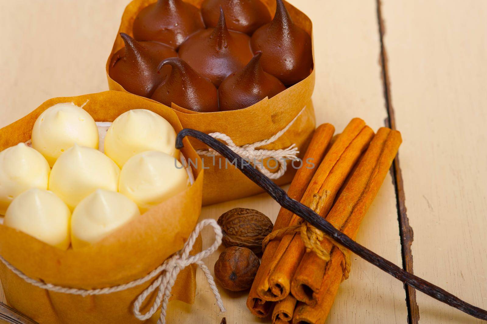 fresh baked chocolate vanilla and spices cream cake dessert over rustic wood table 