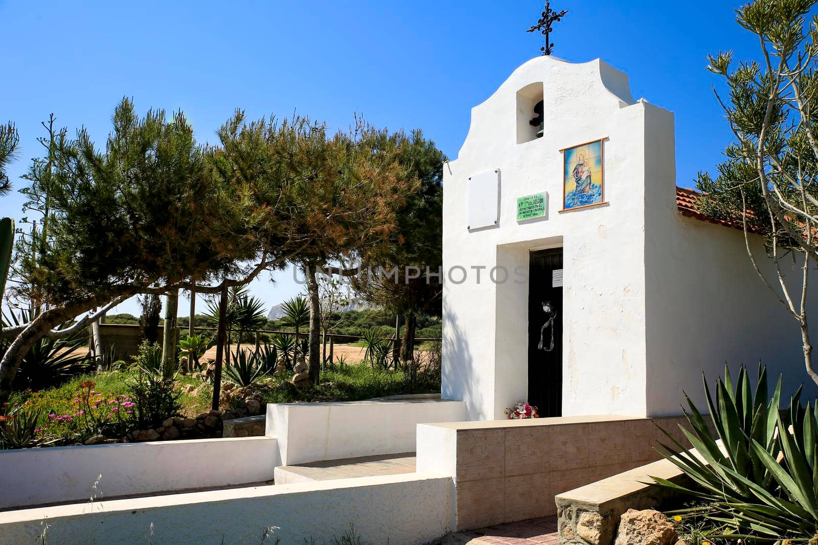 Santa Pola, Alicante, Spain- May 6, 2022: Facade of the Hermitage of Santa Pola Lighthouse seascape under blue sky