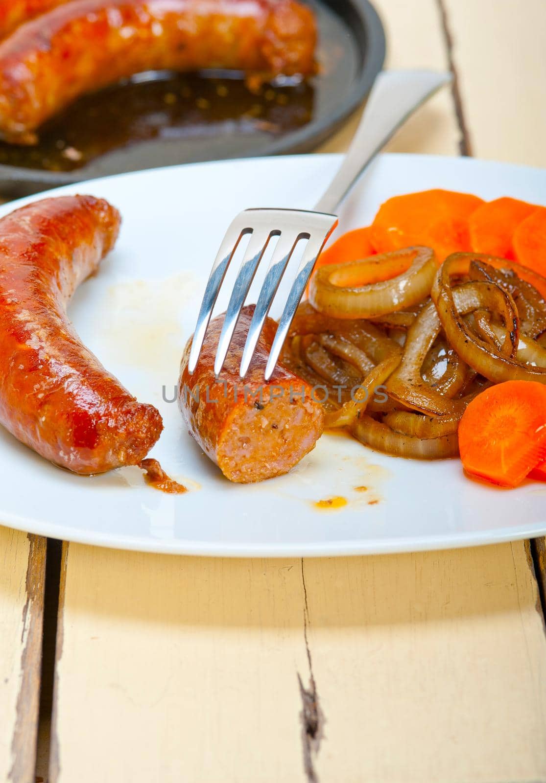 beef sausages cooked on iron skillet  by keko64