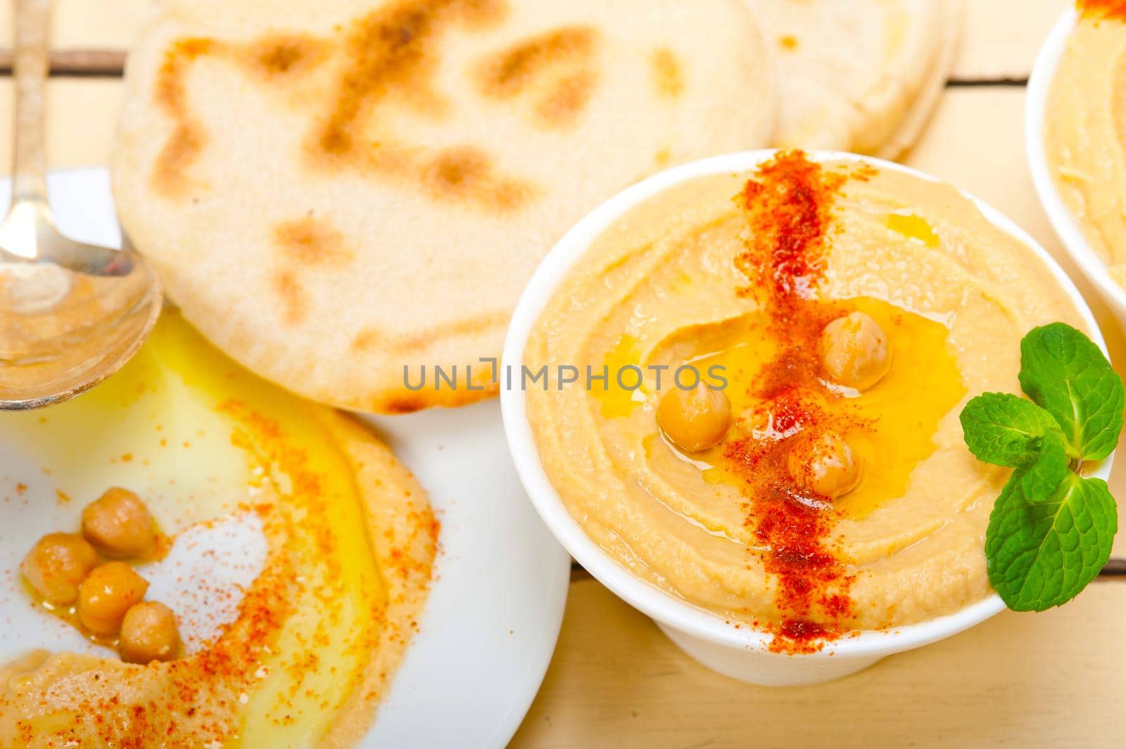 traditional chickpeas Hummus with pita bread and paprika on top 