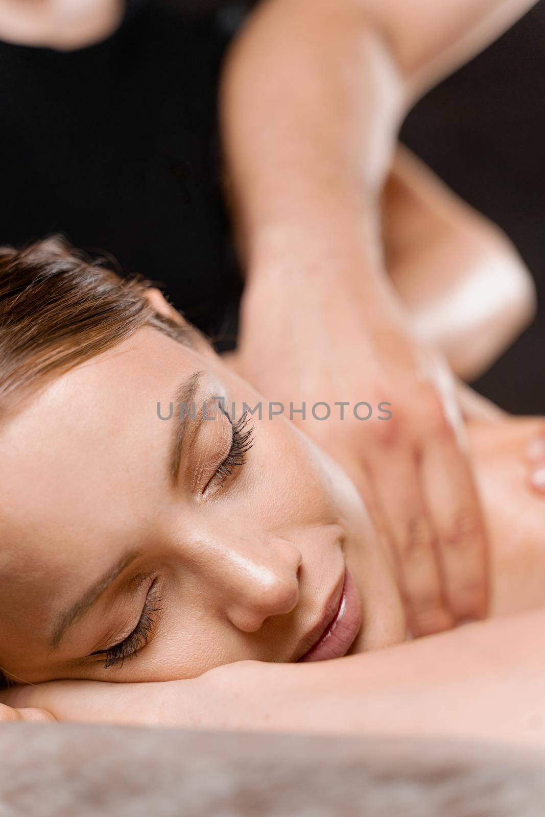 4 hands massage in spa. Two masseurs are making four hands relaxing massage with oil for girl. Relaxation. Manual therapy.
