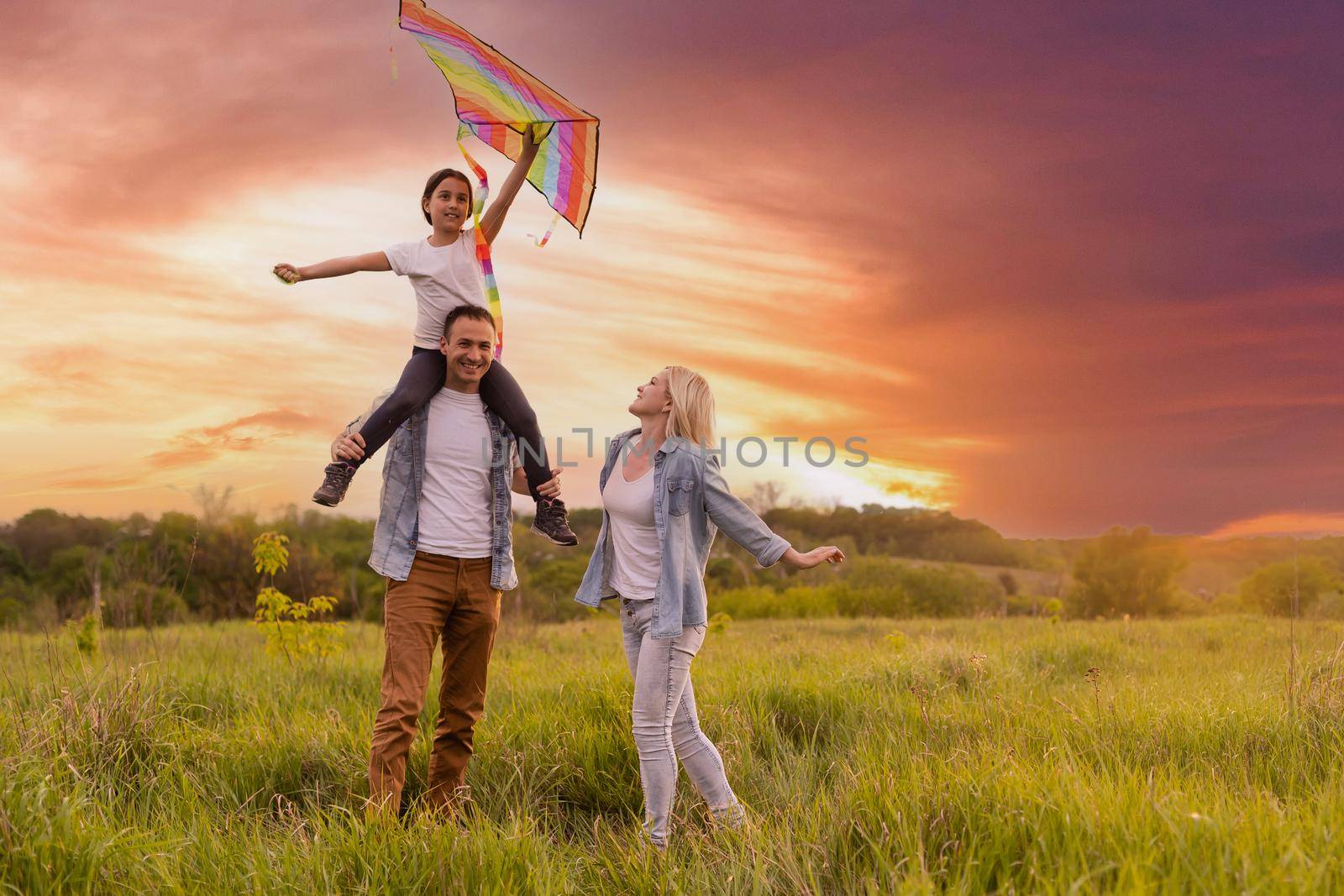 Happy family: mother father and child daughter on nature on sunset by Andelov13