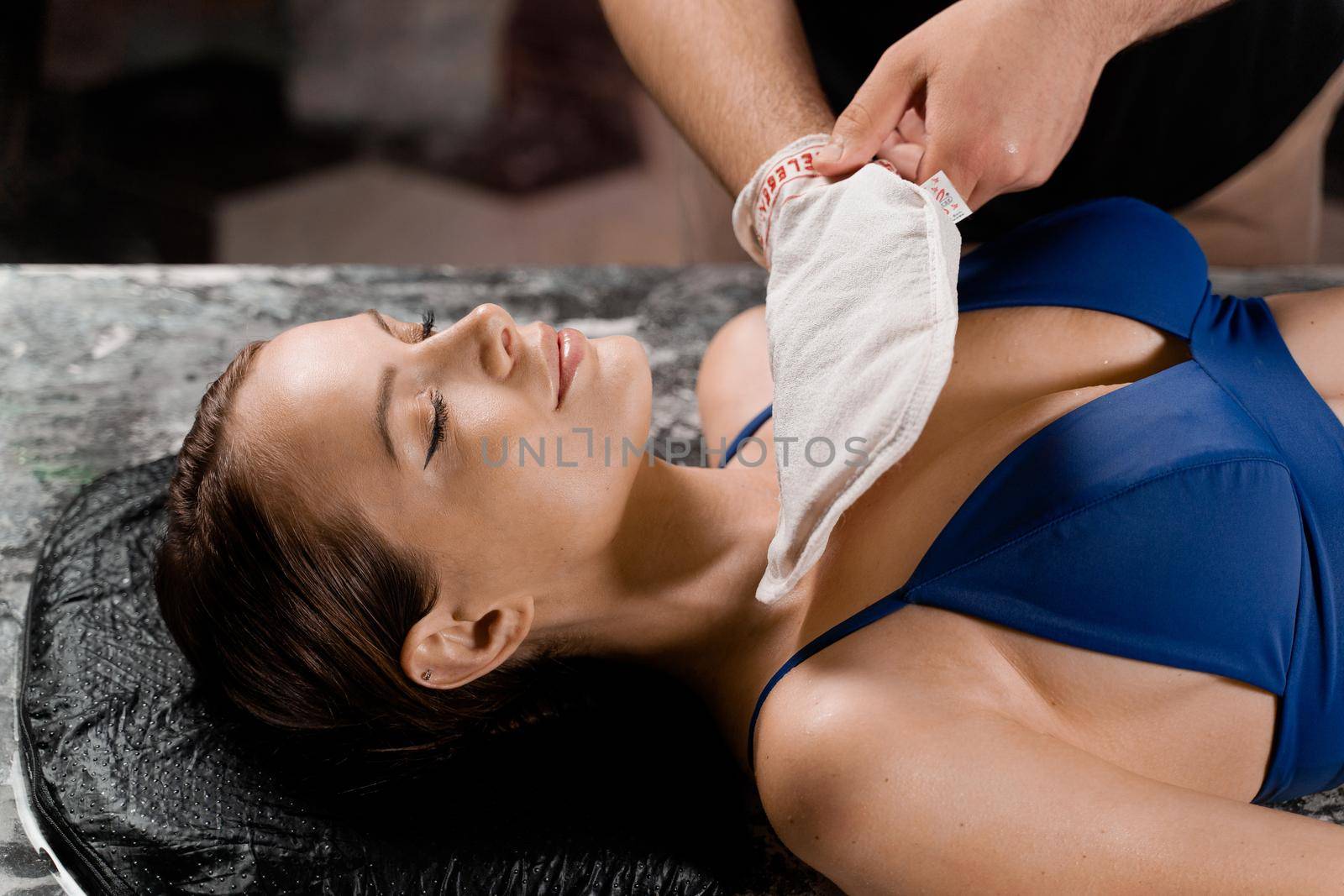 Turkish foam massage and peeling with kese glove. Relaxation in spa centre. Masseur is making massage