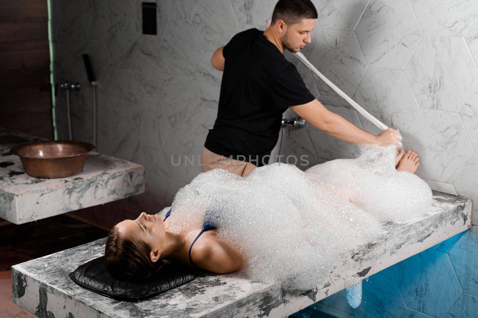 Turkish hammam spa procedure. Foam peeling massage for body