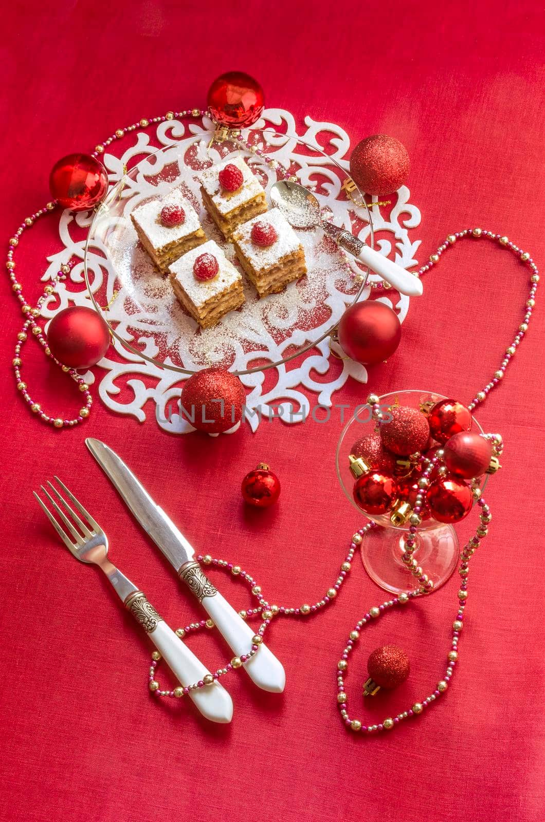 Holiday apple pie bars, garnished with fresh raspberries and Christmas decorations. by zimages