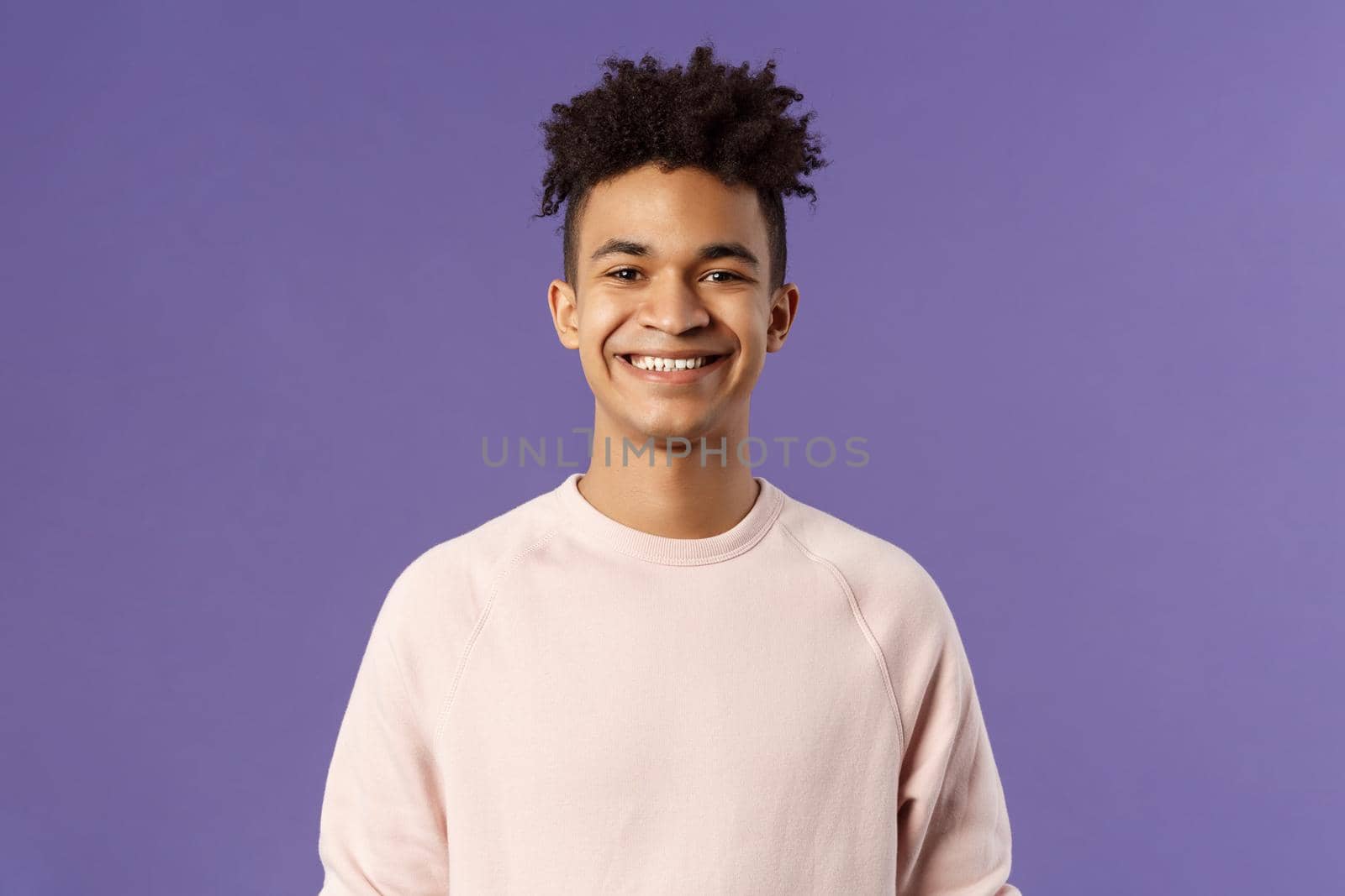 Close-up portrait of cheerful young hipster guy with dreads, smiling optimistic and delighted, standing purple background, having lucky good day, express positivity and joy.
