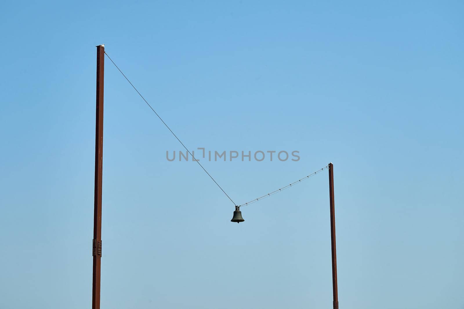 The art piece called Out of Tune by AK Dolven in Folkstone. A bell is hung on a piece of string between two poles.