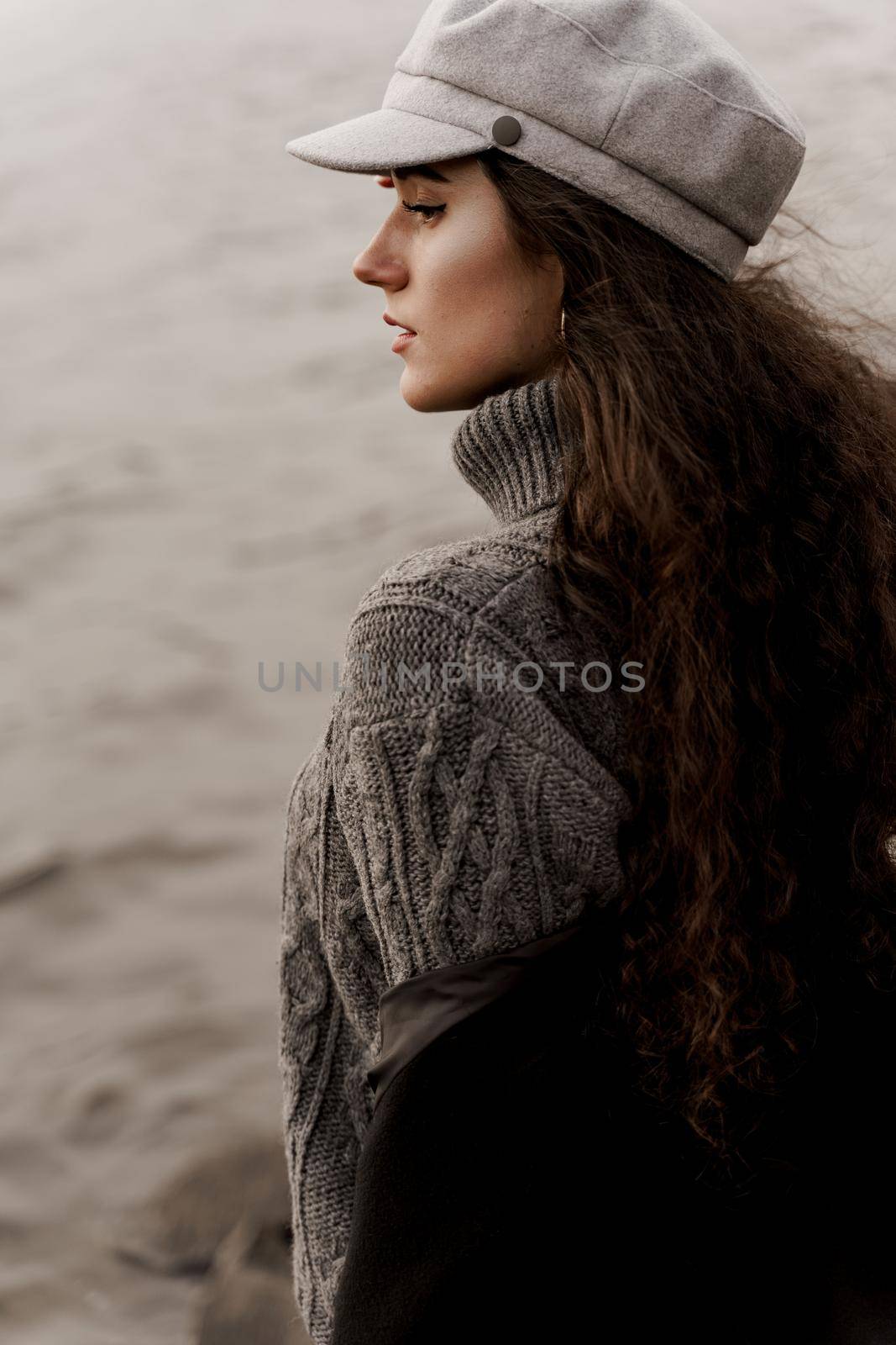 Attractive girl tourist travels around her country. Young woman with curly hair looks at the lake and dreams about her life. by Rabizo